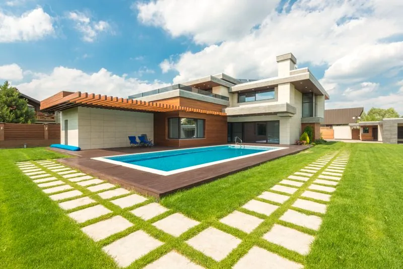Modern luxury home with a pool and landscaped grounds